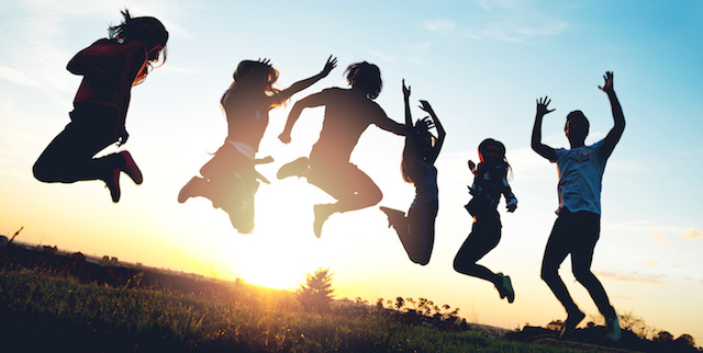 Photograph of people jumping in the air